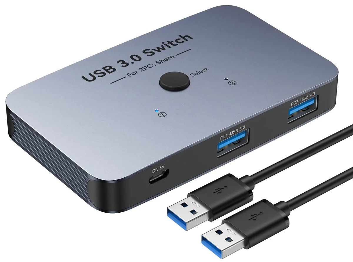 Silver aluminum box with two push buttons and four USB ports, two cables attached