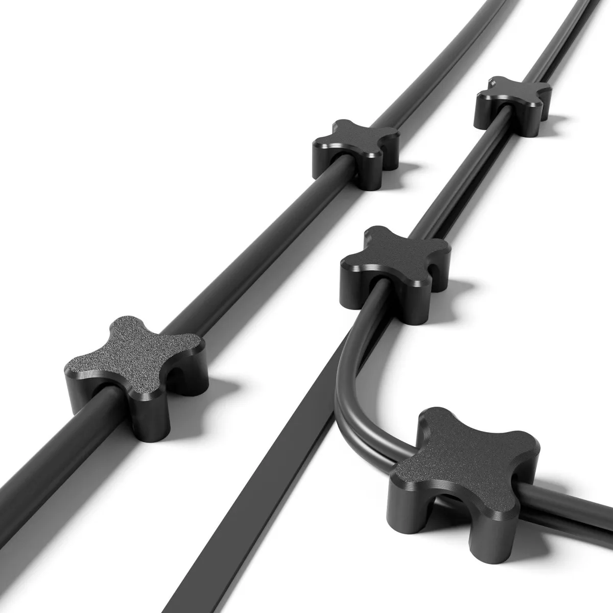 Ten black square magnetic cable clips with adhesive pads, each 30 millimetres wide