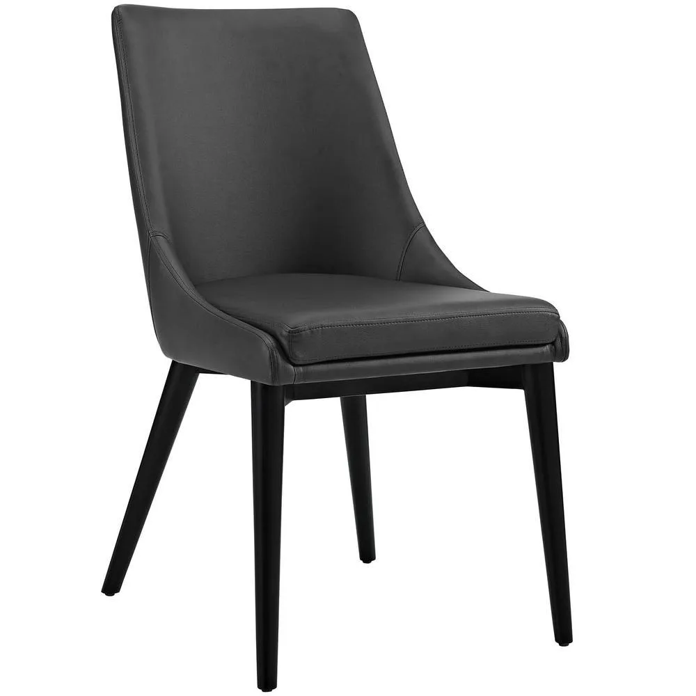 Black vinyl dining chair with tapered rubberwood legs and dense foam padding