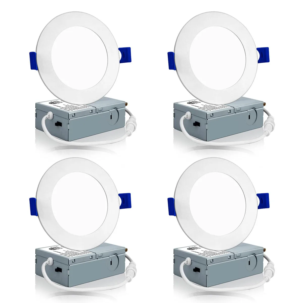 Four white 4-inch canless LED downlights with clear prismatic lenses and slim junction boxes