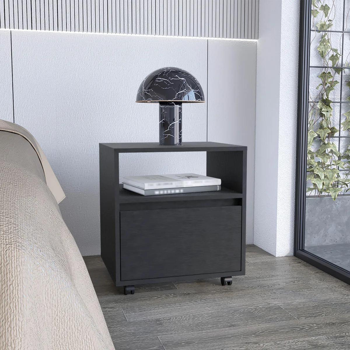 Black particle-board nightstand on casters with one drawer and open shelf