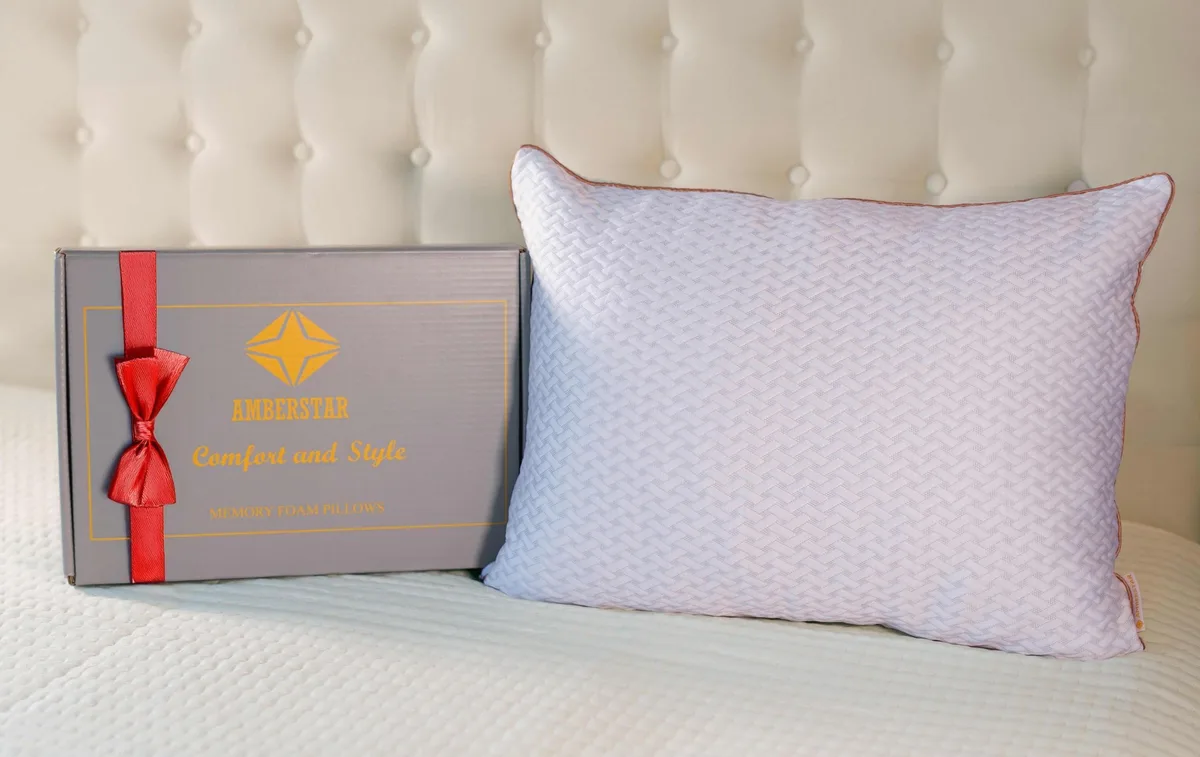 White rectangular pillow with light silver piping and amber edge trim