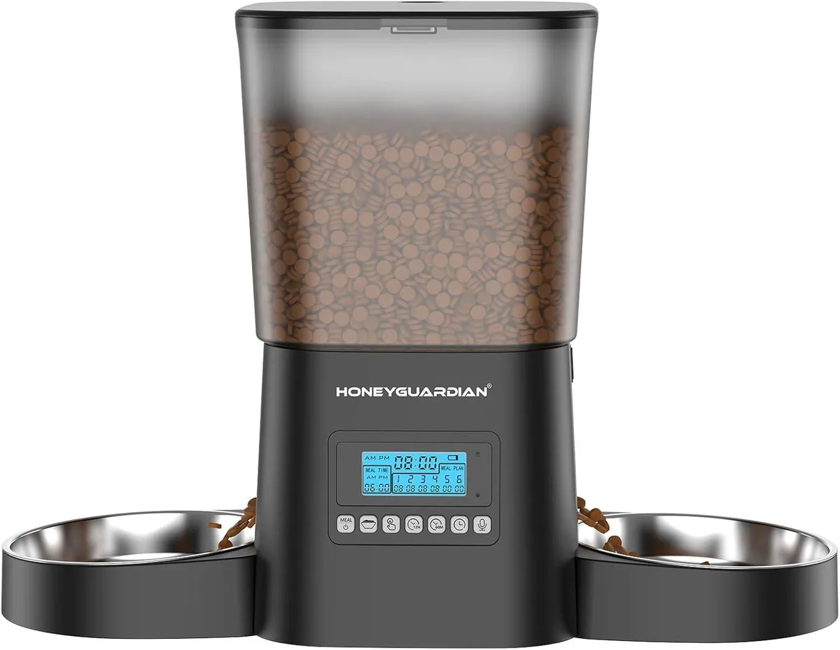 Black automatic cat feeder with dual stainless steel bowls and top-mounted control panel