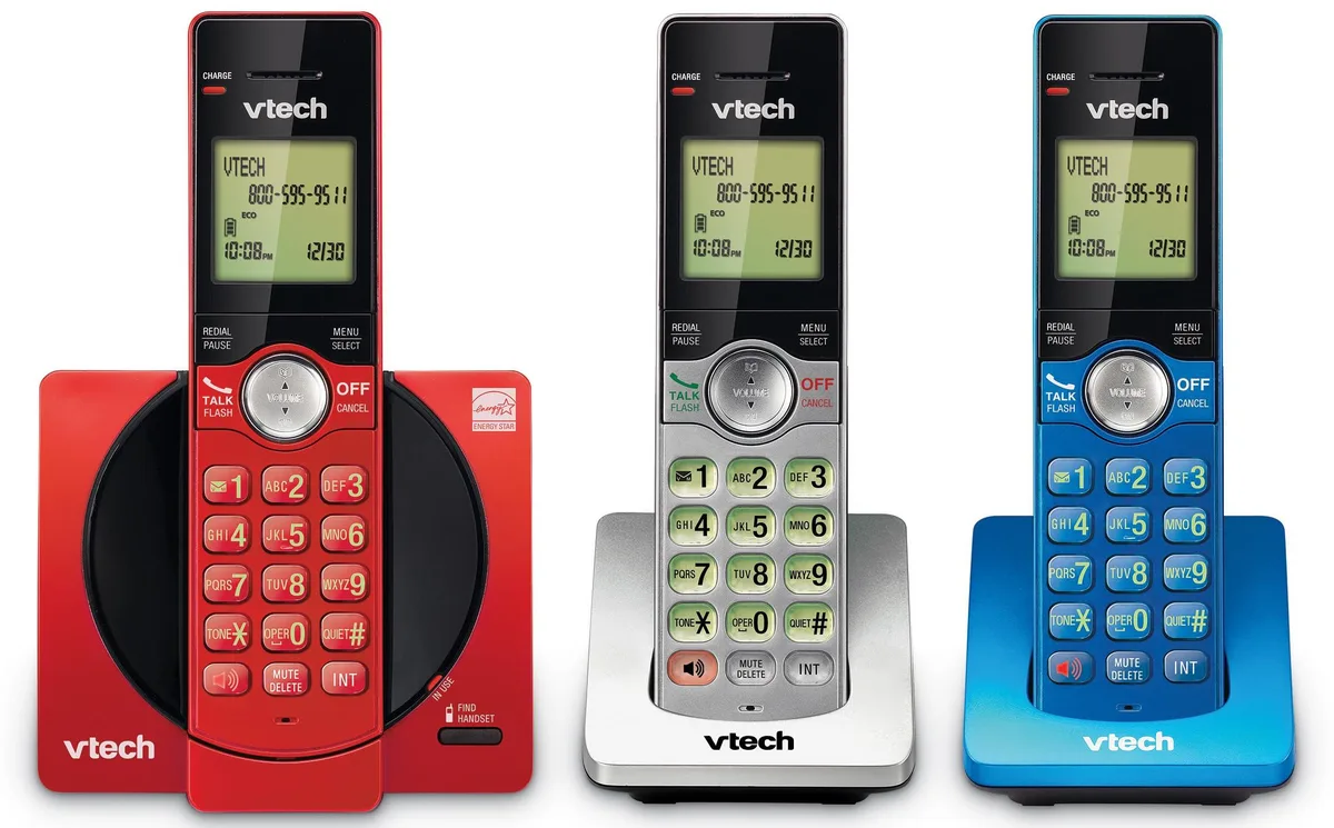 Three cordless handsets in red, blue and grey with illuminated keypads and base unit