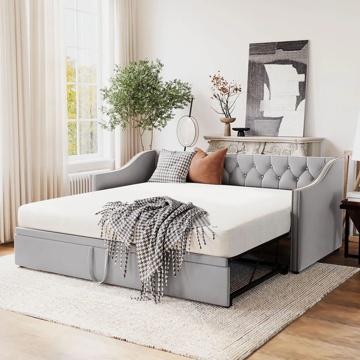 Gray upholstered twin daybed with pop-up trundle visible, backrest and armrests shown