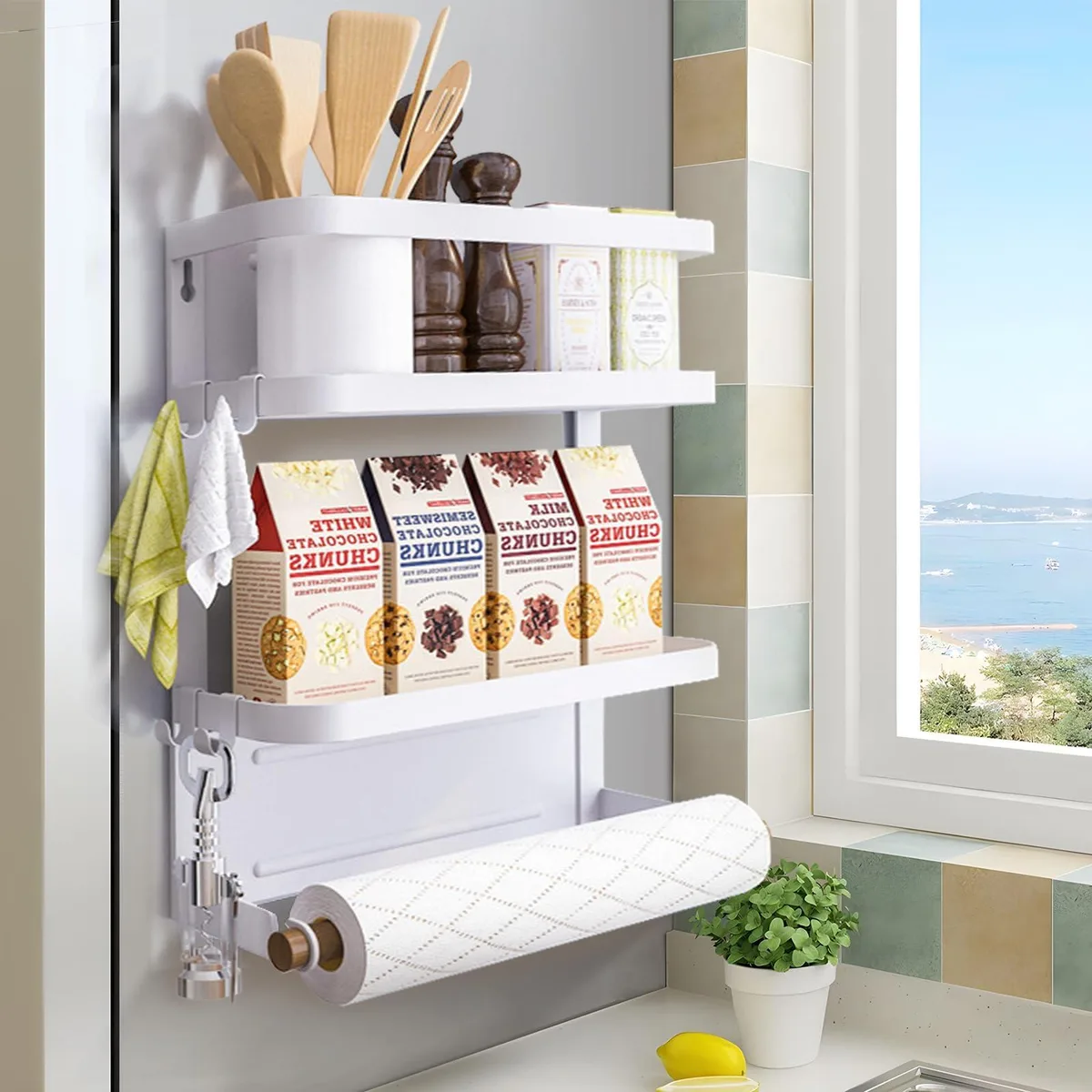 White magnetic two-tier shelf on fridge, wood rod and hooks attached