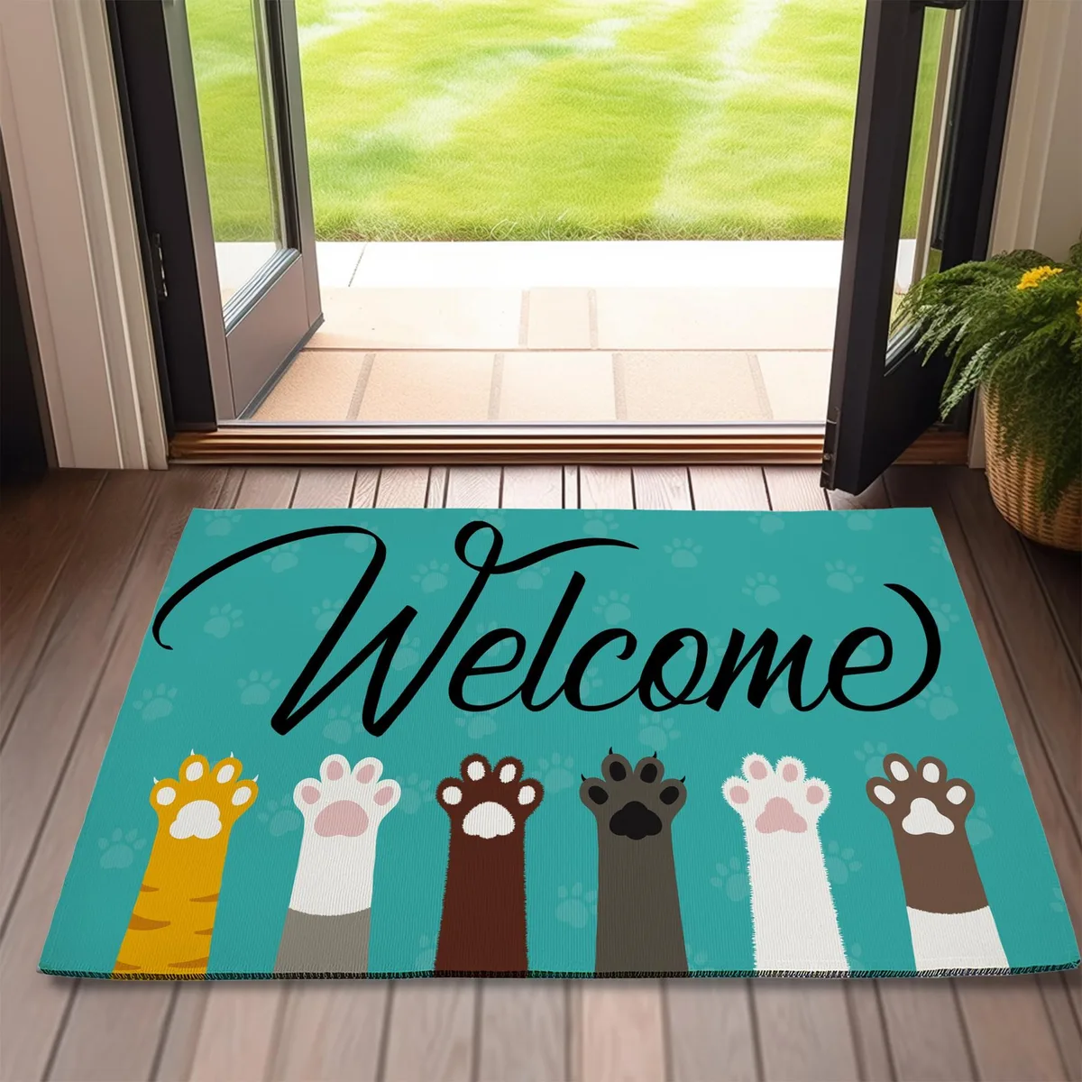 Rectangular door mat with cartoon cat and dog paw print design, low-profile polyester surface, non-slip rubber backing, 17 by 30 inches