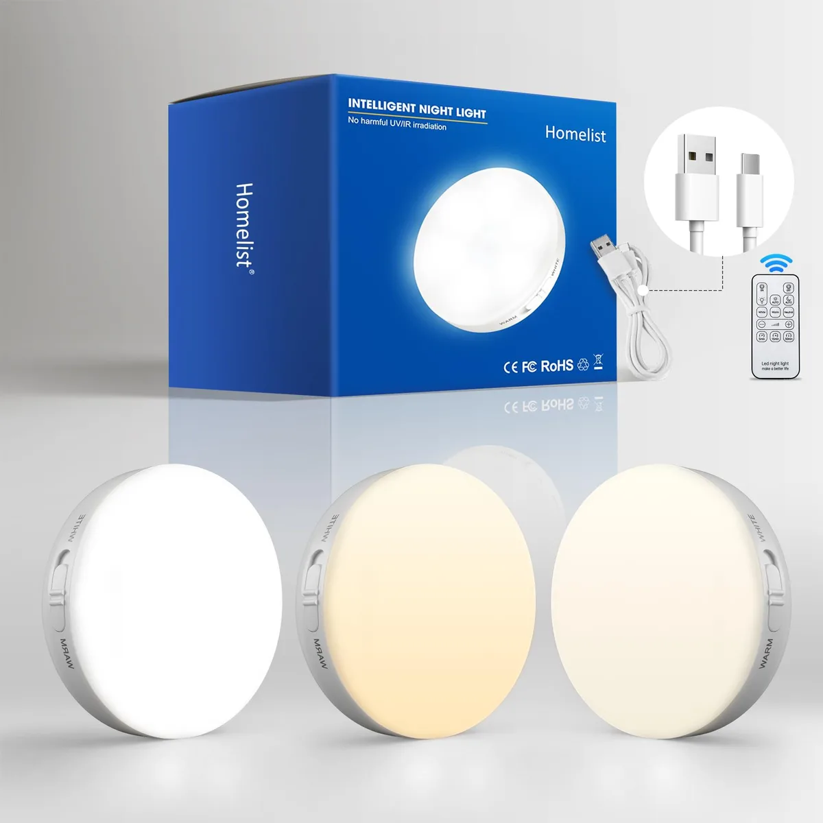 Three white plastic puck lights with remote control, rechargeable via USB cable