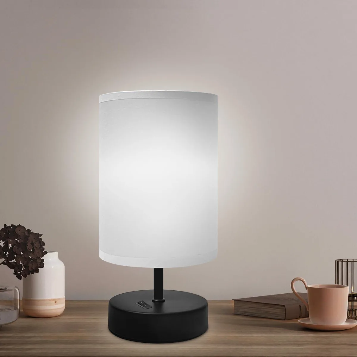 Small gray fabric shade table lamp on black base, nine inches tall