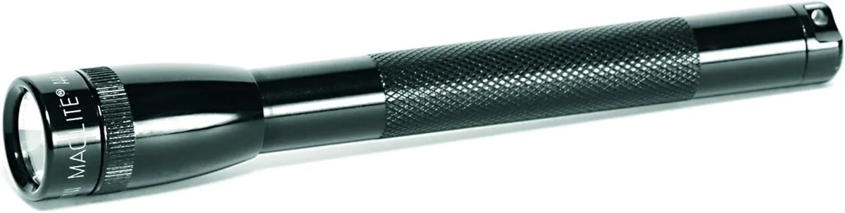 Black compact flashlight with twist head and pocket clip