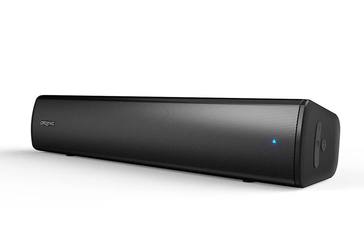 Compact black rectangular soundbar with rounded edges, USB-C and 3.5 mm cables included