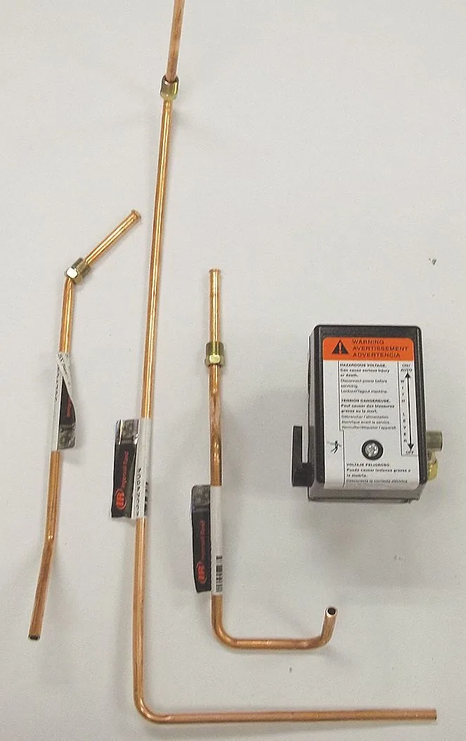 Orange pressure switch with attached tube assemblies