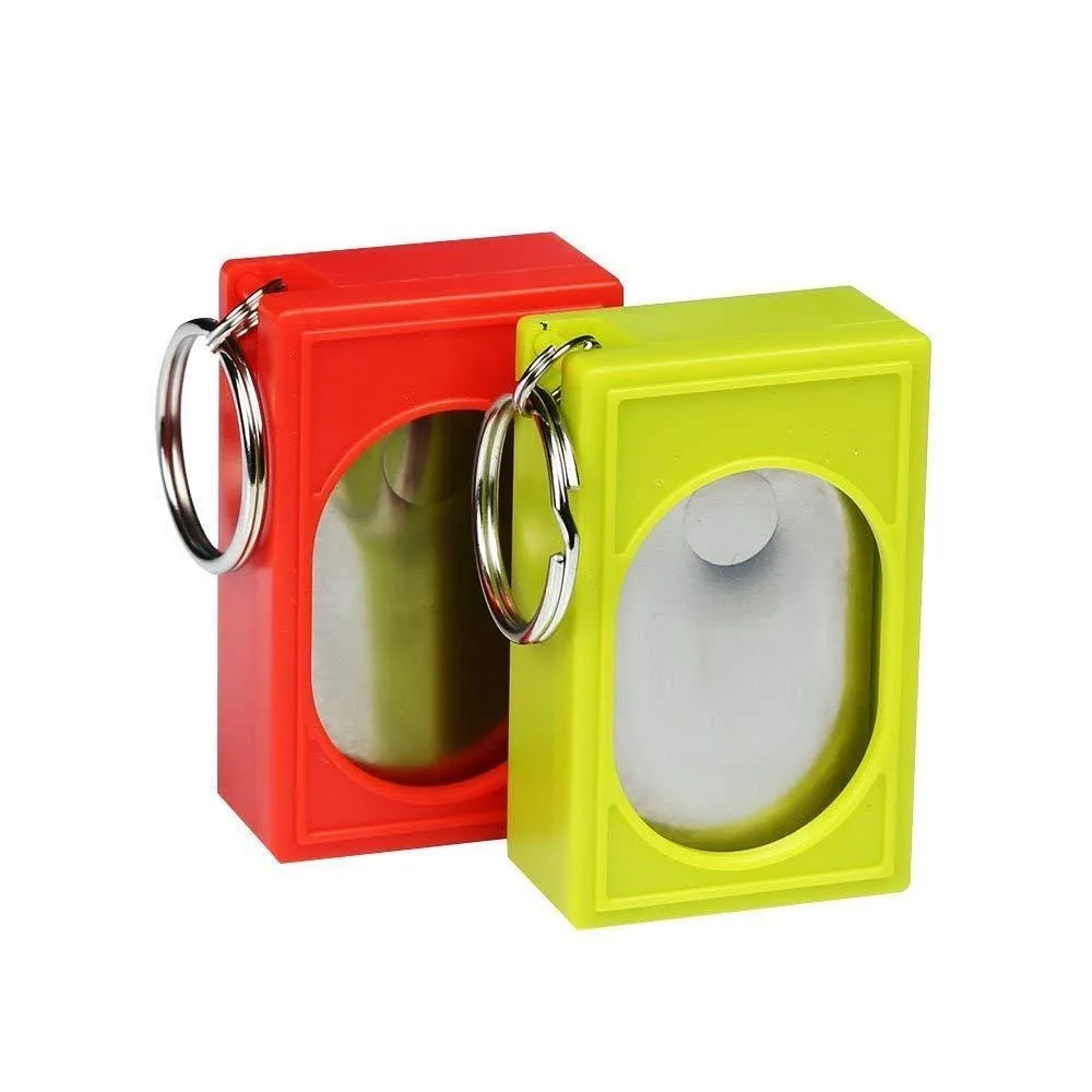 Two small plastic clickers in white and black, palm-sized with raised buttons