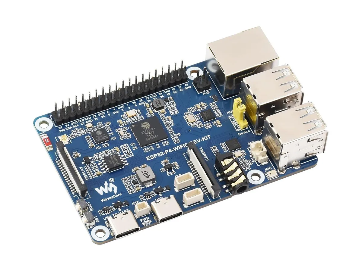 Green rectangular development board with pin headers and ESP32 chips