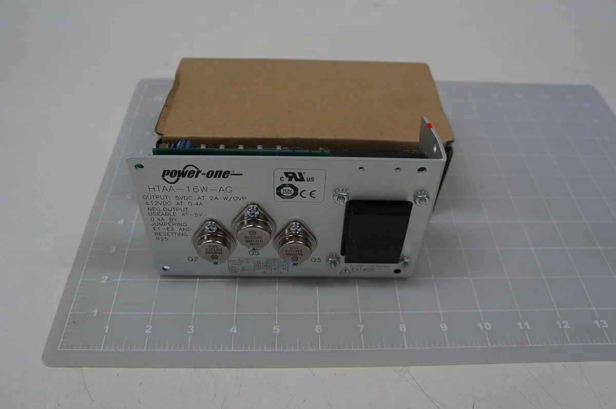 Open-frame linear power supply, silver metal chassis, panel-mount tabs, screw terminals visible