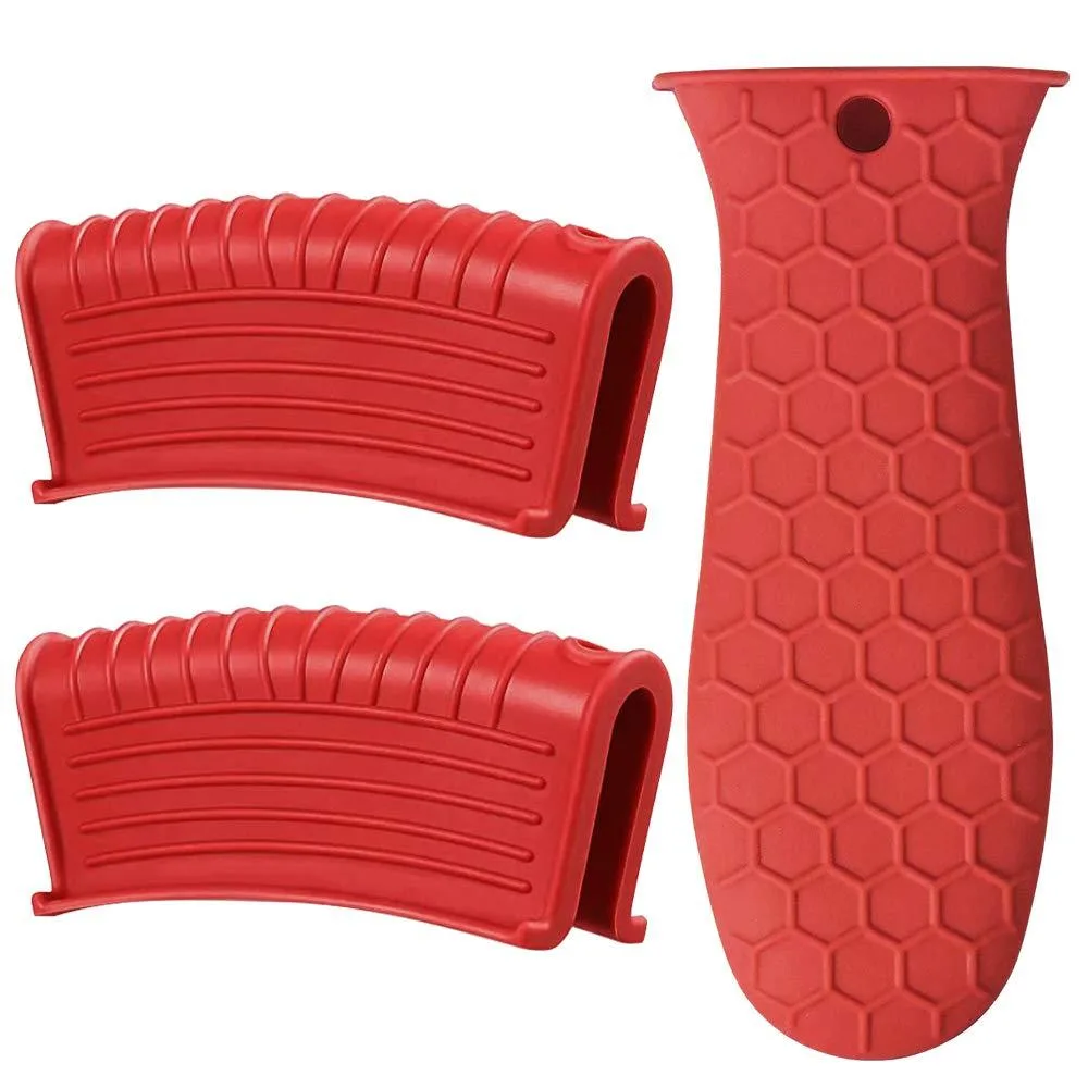 Three red silicone handle sleeves on a light surface