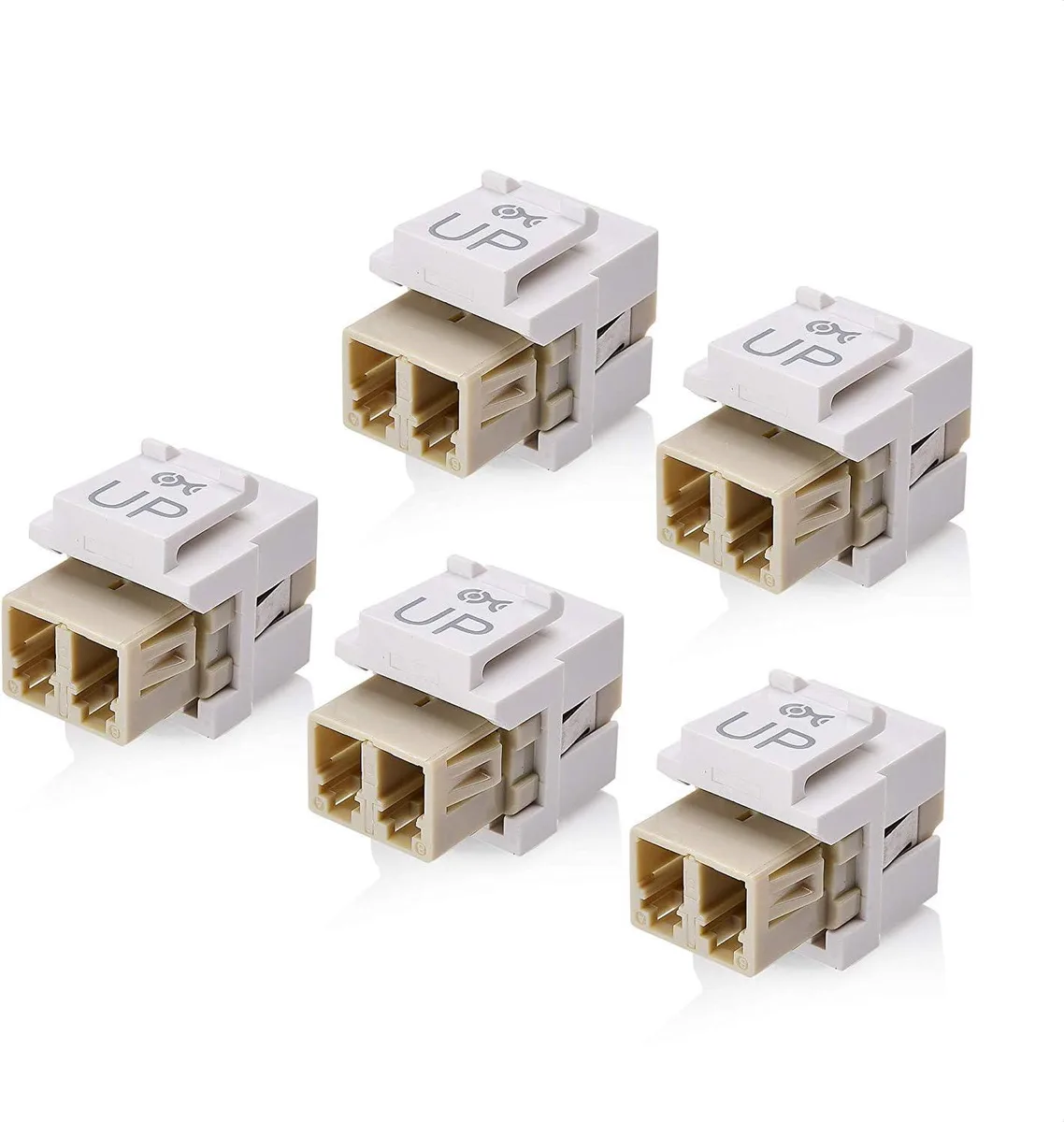 Five white duplex LC fiber keystone couplers with protective caps