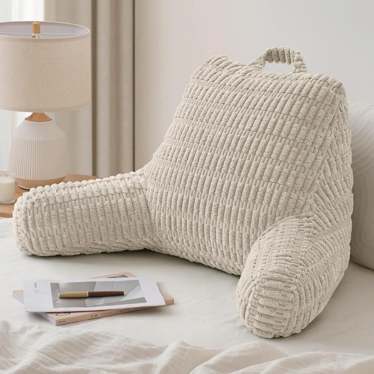 Pink reading pillow with side arms and pockets, shredded memory foam fill, washable cover, top carry handle