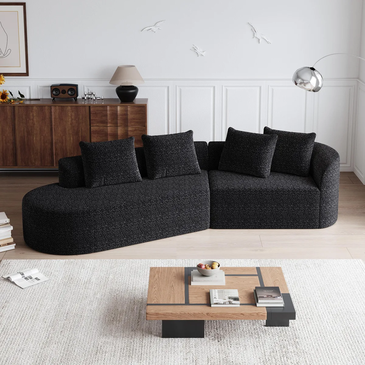 Large black chenille sectional sofa with four throw pillows, curved cloud shape