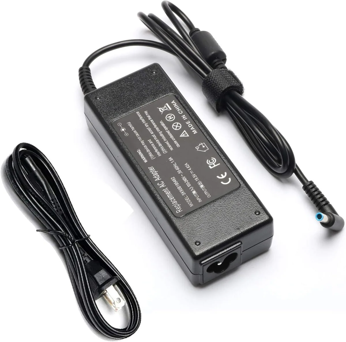 A black rectangular laptop charger with a blue tip and detachable mains lead