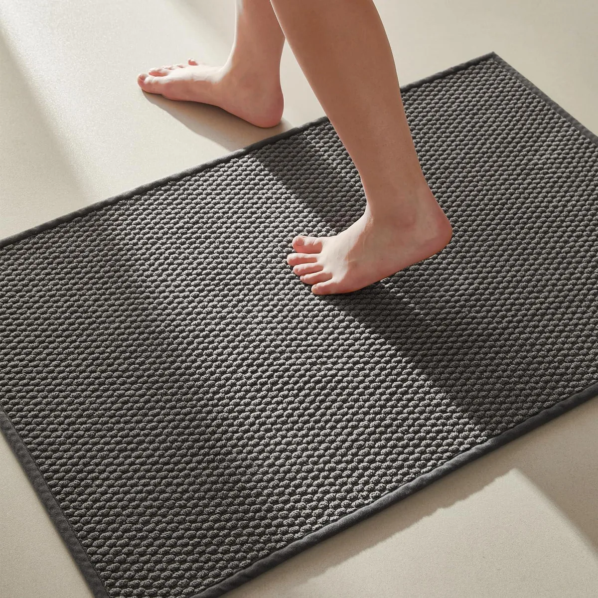 Dark grey rectangular chenille bath mat 16 by 24 inches