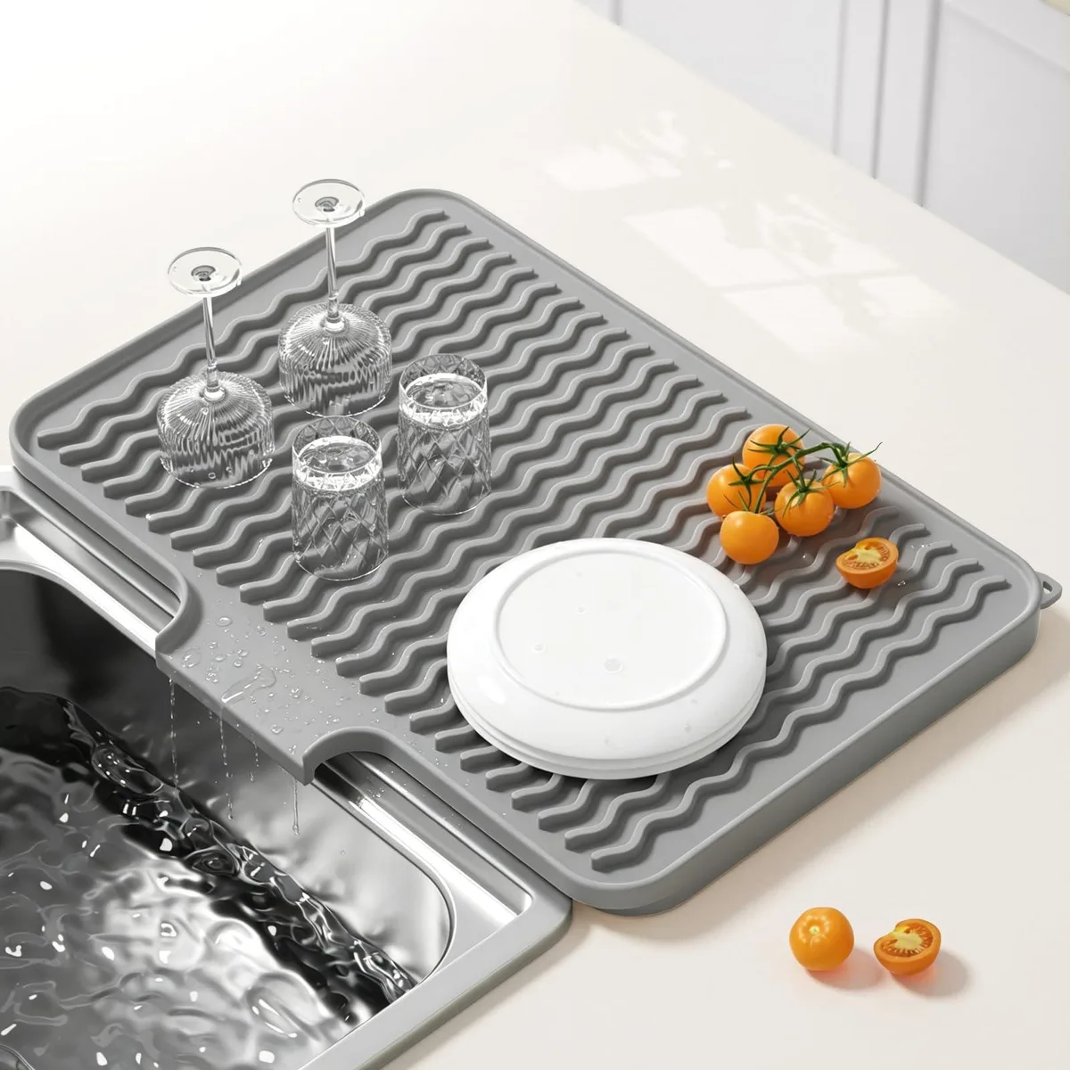 Gray silicone drying mat with wavy ridges and hanging loop, 16 by 12 inches