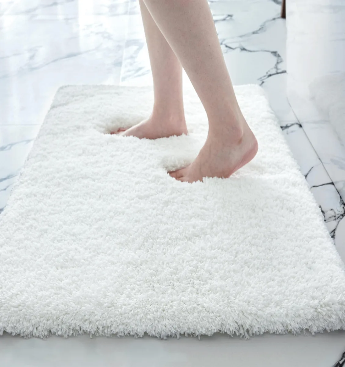 White rectangular bath mat with thick fluffy pile and non-slip backing