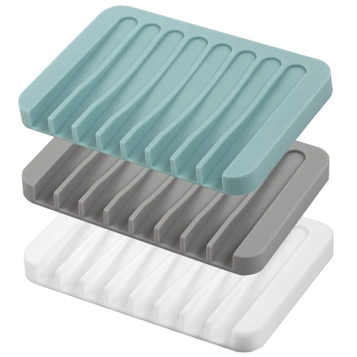 Three flexible silicone soap dishes in white, grey and teal with grooved self-draining design