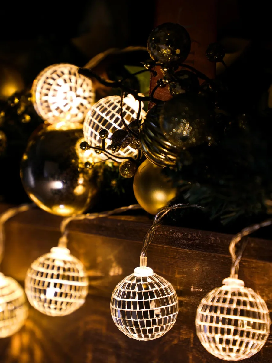 A 70.92 inch copper wire strand holding 30 tiny 1.57 inch warm silver disco balls glowing warm white