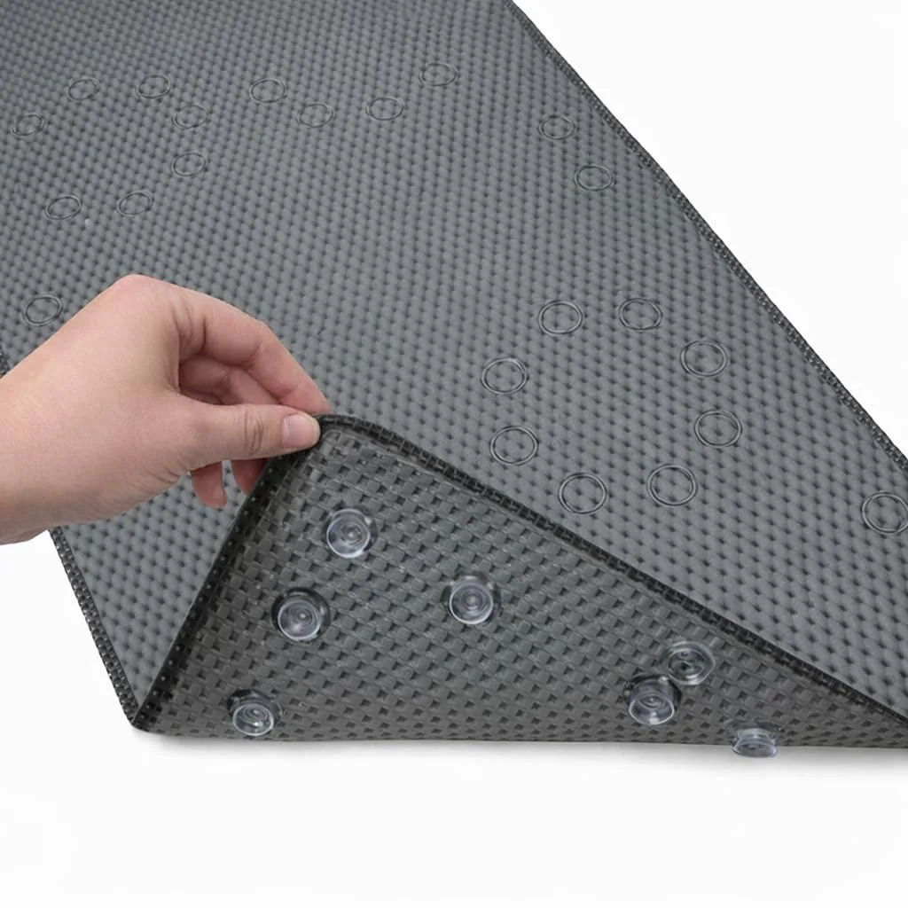 Dark grey rectangular bath mat with suction cups and drain holes 36 x 17 in