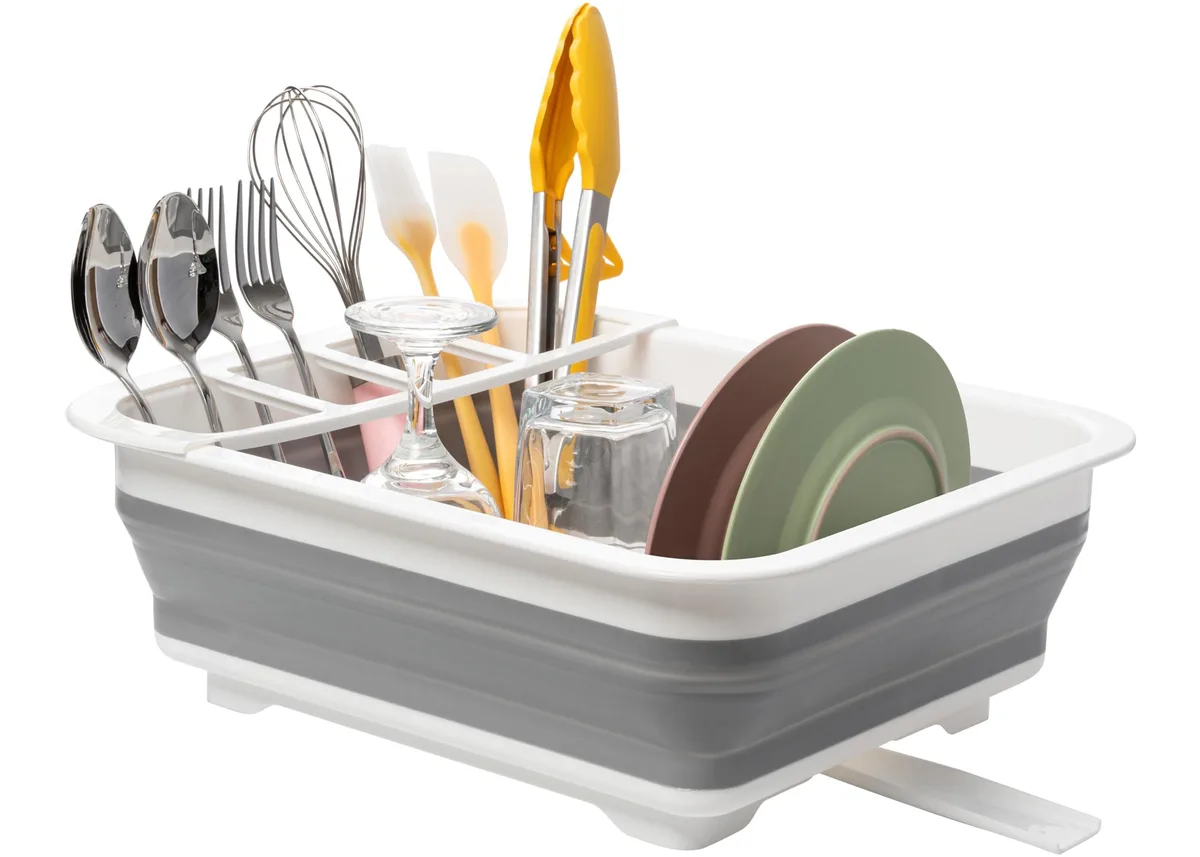 Collapsible white and grey dish drying rack with plate grooves and utensil holder, shown expanded
