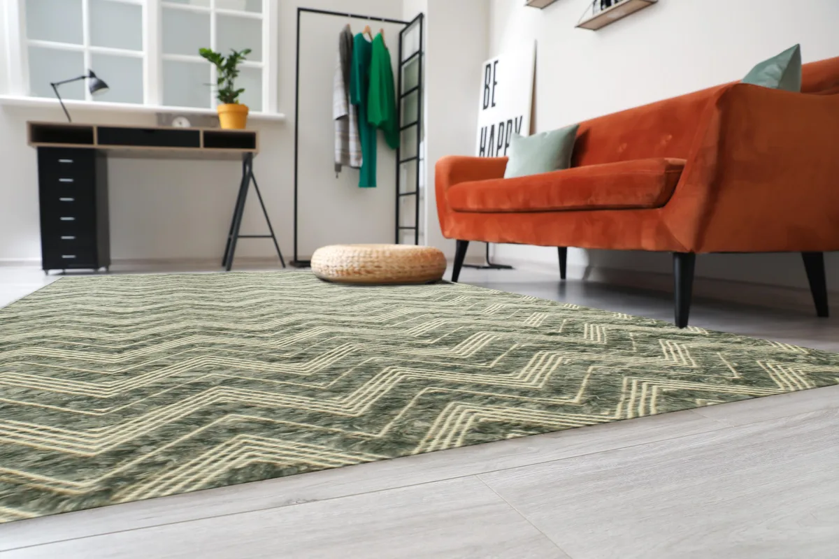 Handmade wool rug in green with geometric pattern