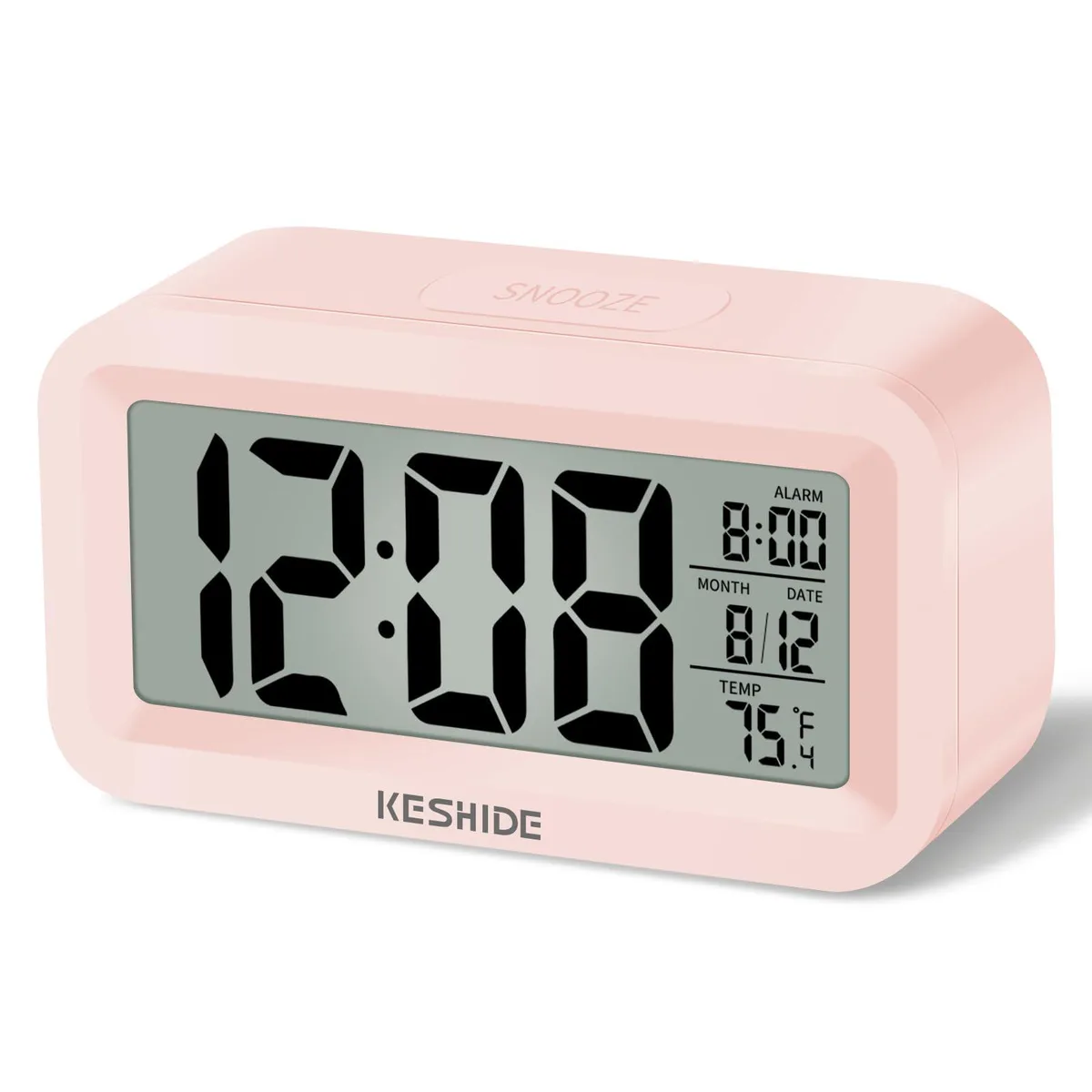 Pink rectangular digital alarm clock with LCD display showing time and temperature, tabletop battery powered design