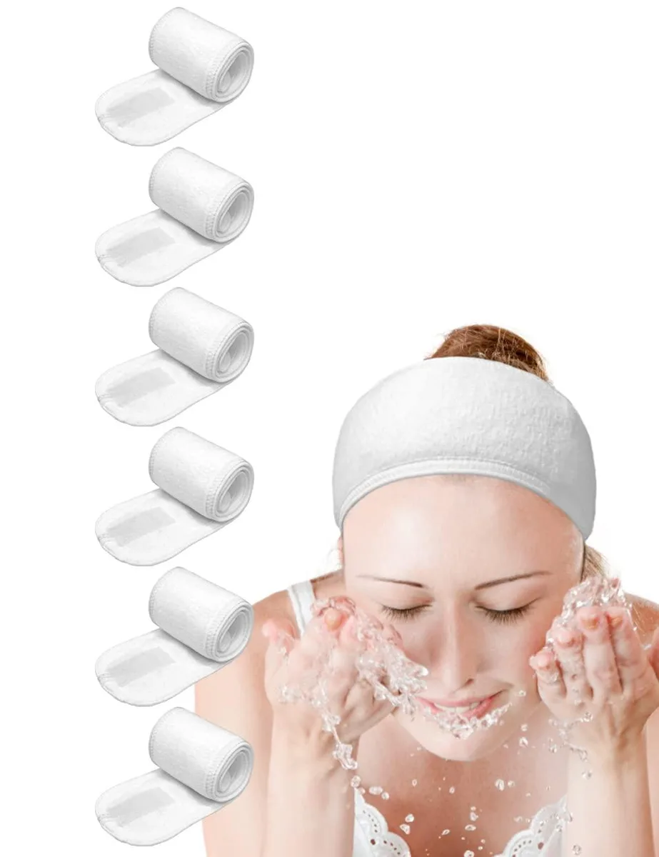 Six white terry-cloth spa headbands with Velcro closures, folded flat