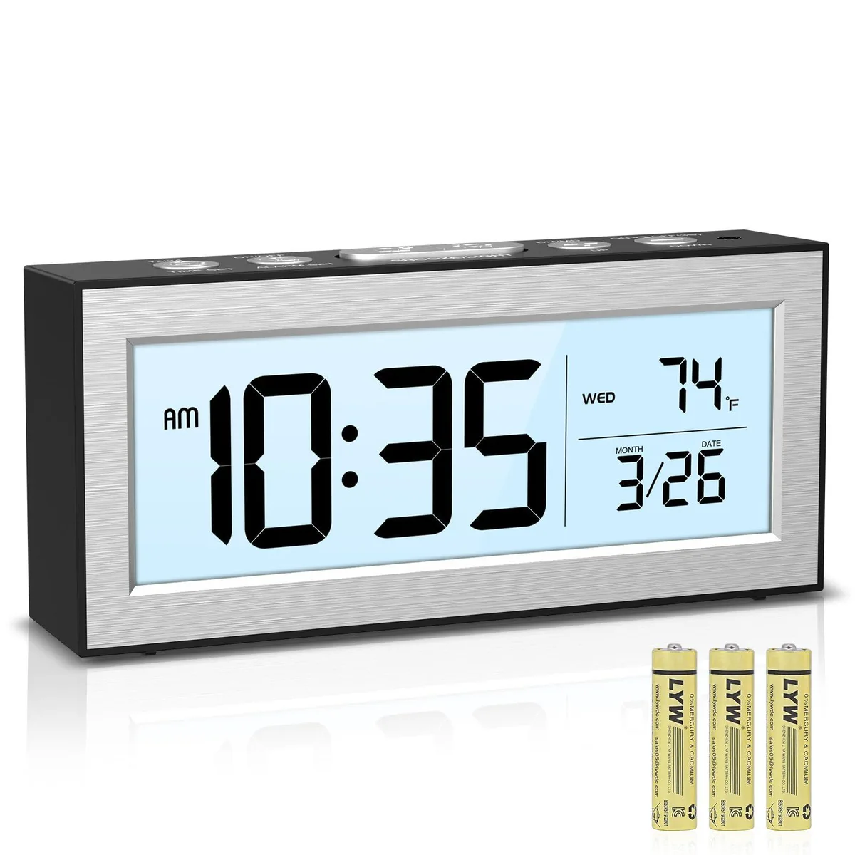 Small silver digital alarm clock with LCD display showing time date and temperature