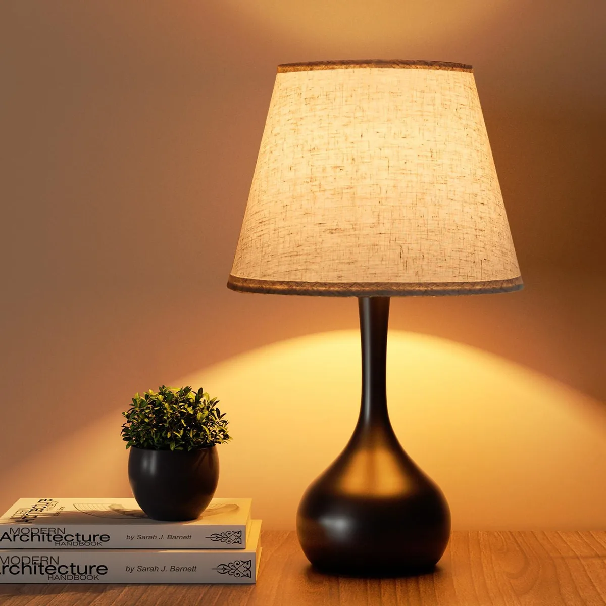 A 17.32 inch tall table lamp with a glossy metal base and beige fabric shade