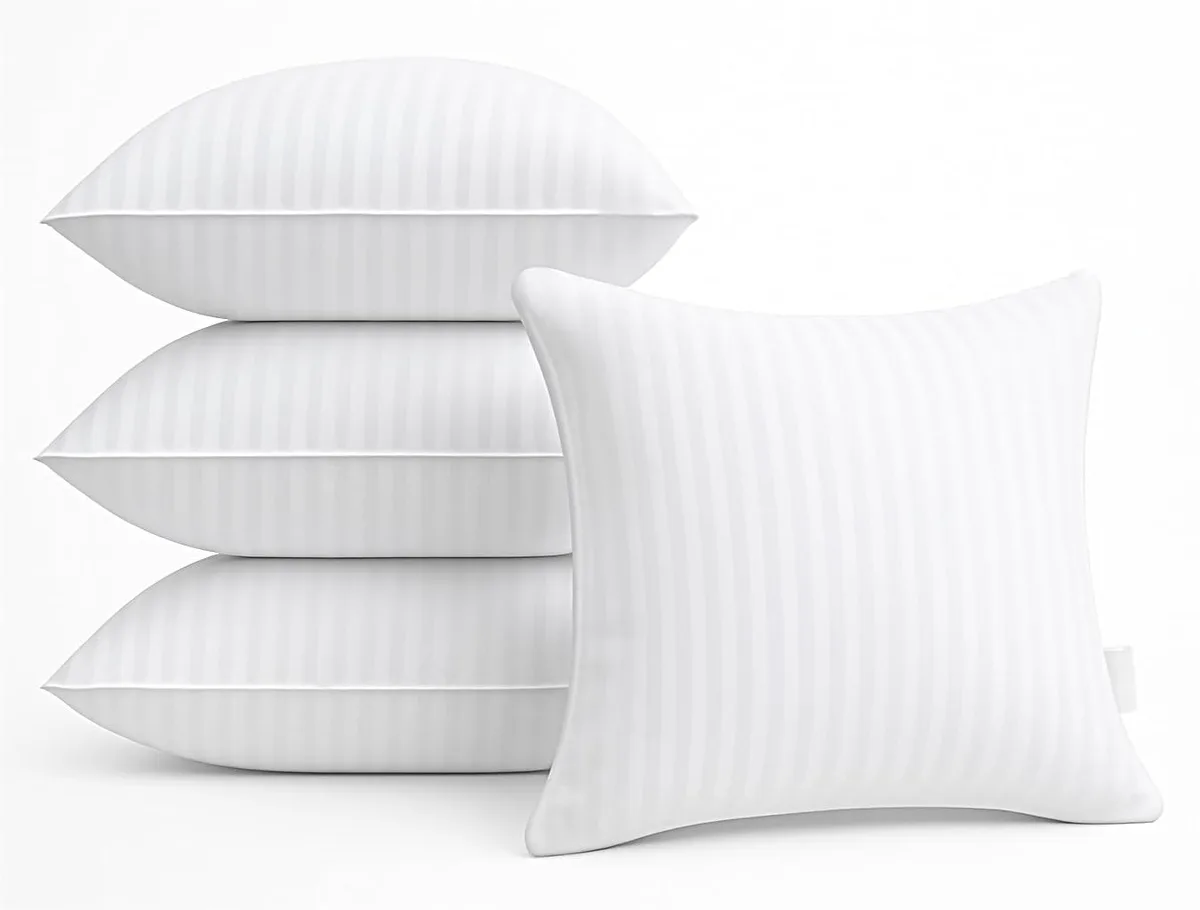 Four white square pillow inserts with striped cotton covers and hidden zippers, vacuum-packed