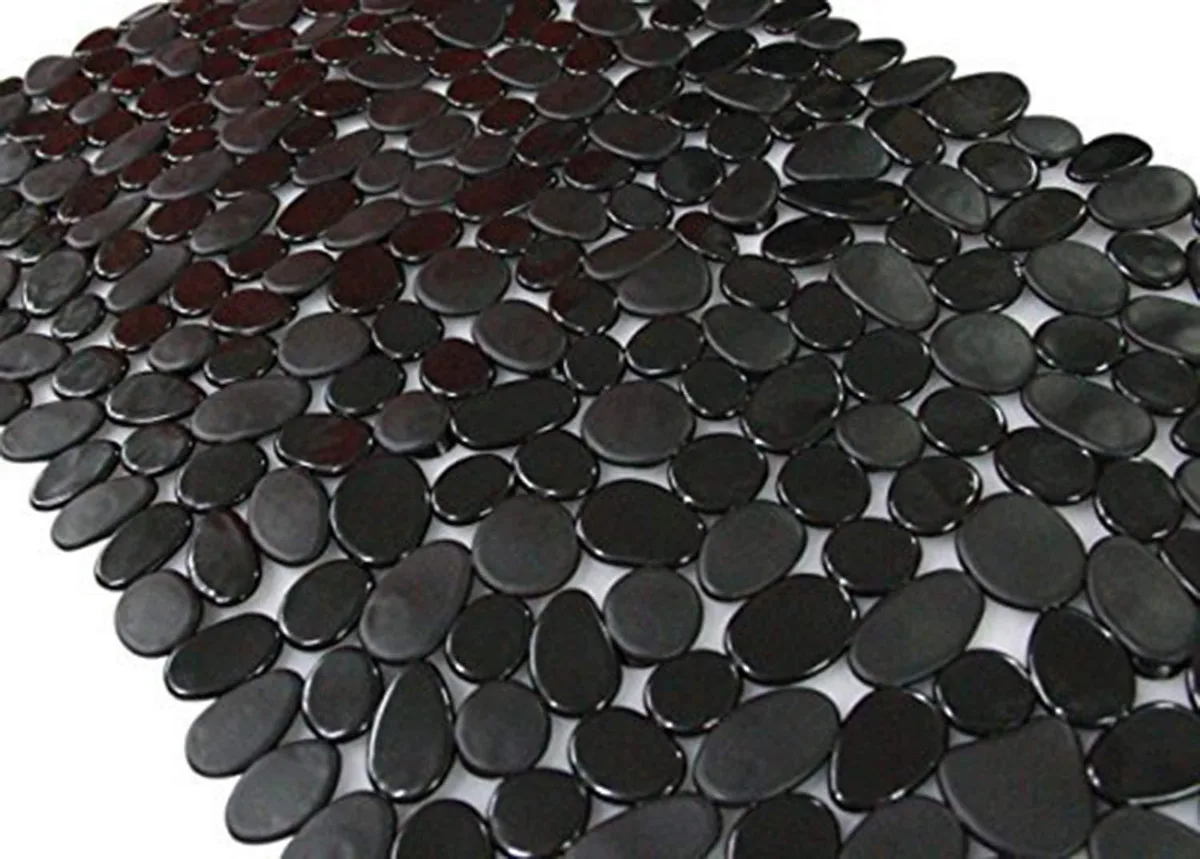 Black pebble-textured bath mat 35 by 16 inches with suction cups on smooth underside