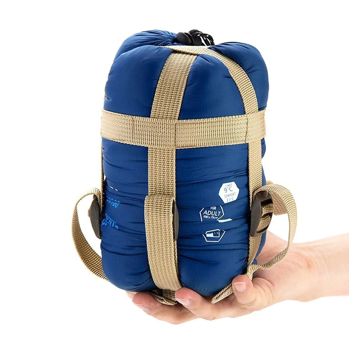 Beige envelope sleeping bag with dark blue zipper, rolled in compression sack
