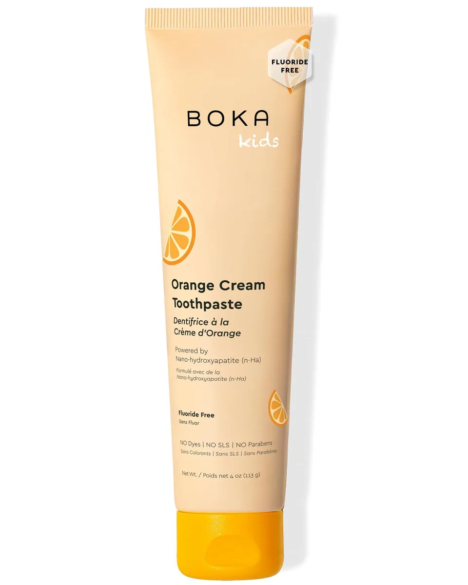 White 4 oz toothpaste tube with orange accents standing upright