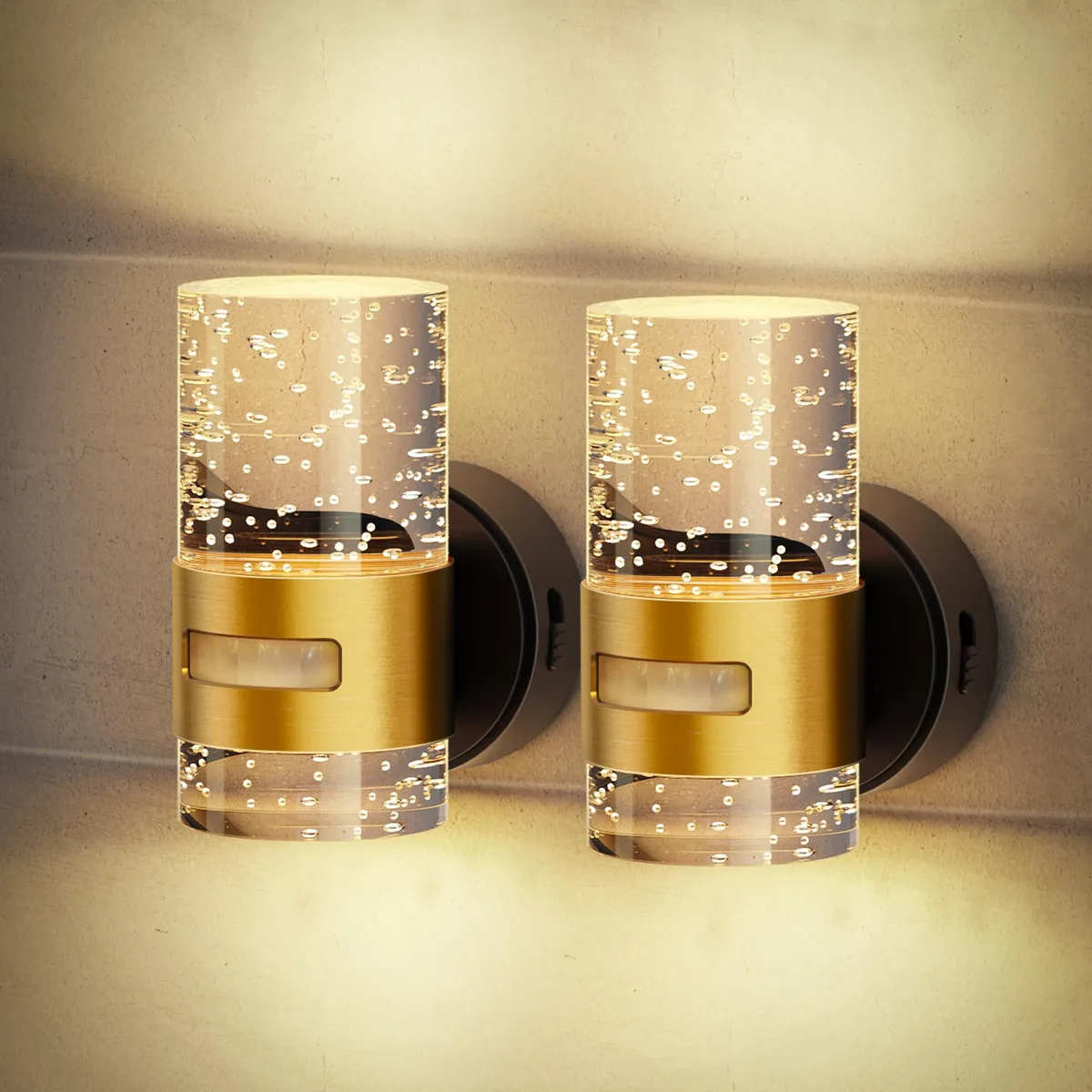 Two white rectangular LED night lights with clear prismatic shades and brushed gold accent bands, wall-mounted on a white surface