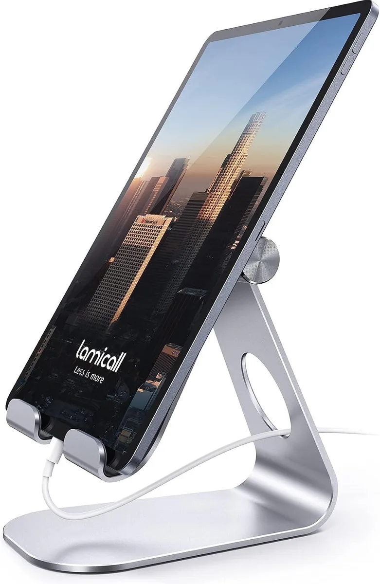 Silver adjustable tablet stand with rubber grips, folded flat on desk