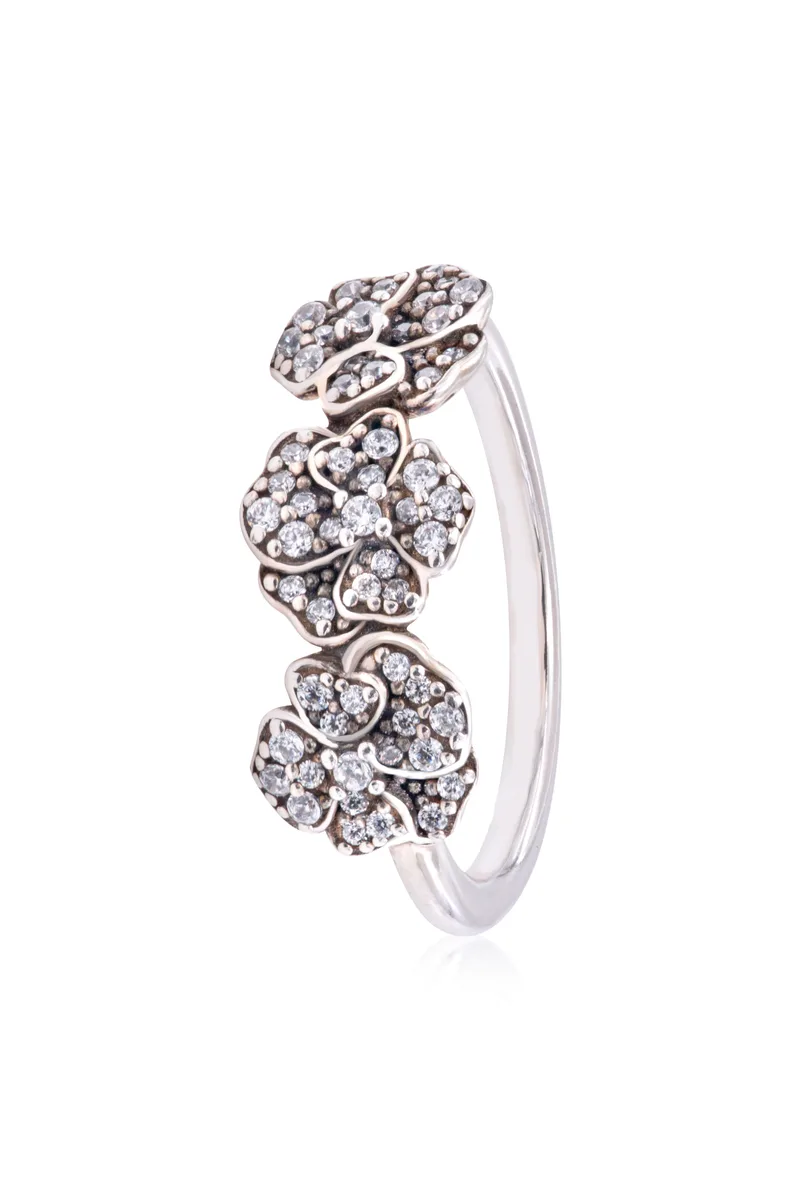 Sterling silver ring with three pansy flowers set with cubic zirconia on a polished band