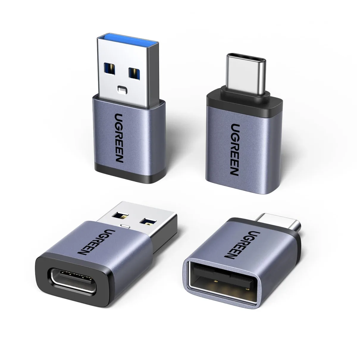 Four small USB adapters, two each type, matte space-grey aluminium finish