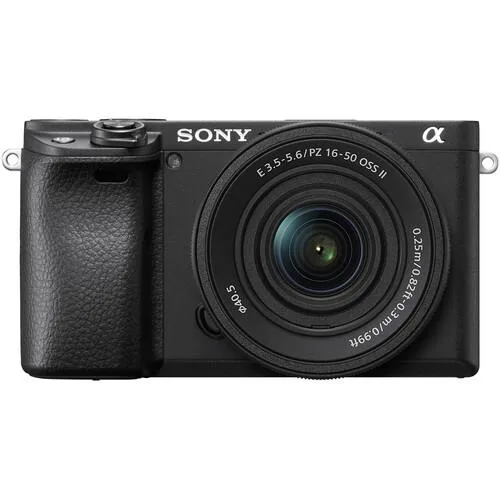 Black compact mirrorless camera body with silver 16-50mm zoom lens attached, 3-inch tilting touchscreen visible