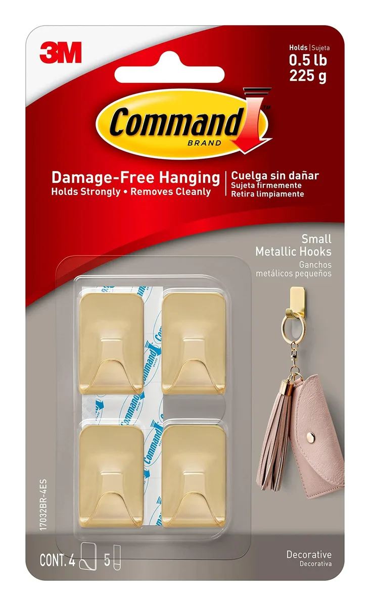 Four small brass-coloured metallic hooks with five adhesive strips