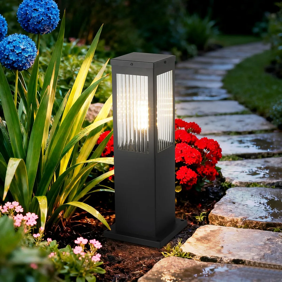Black cylindrical bollard light with glass top and E26 socket
