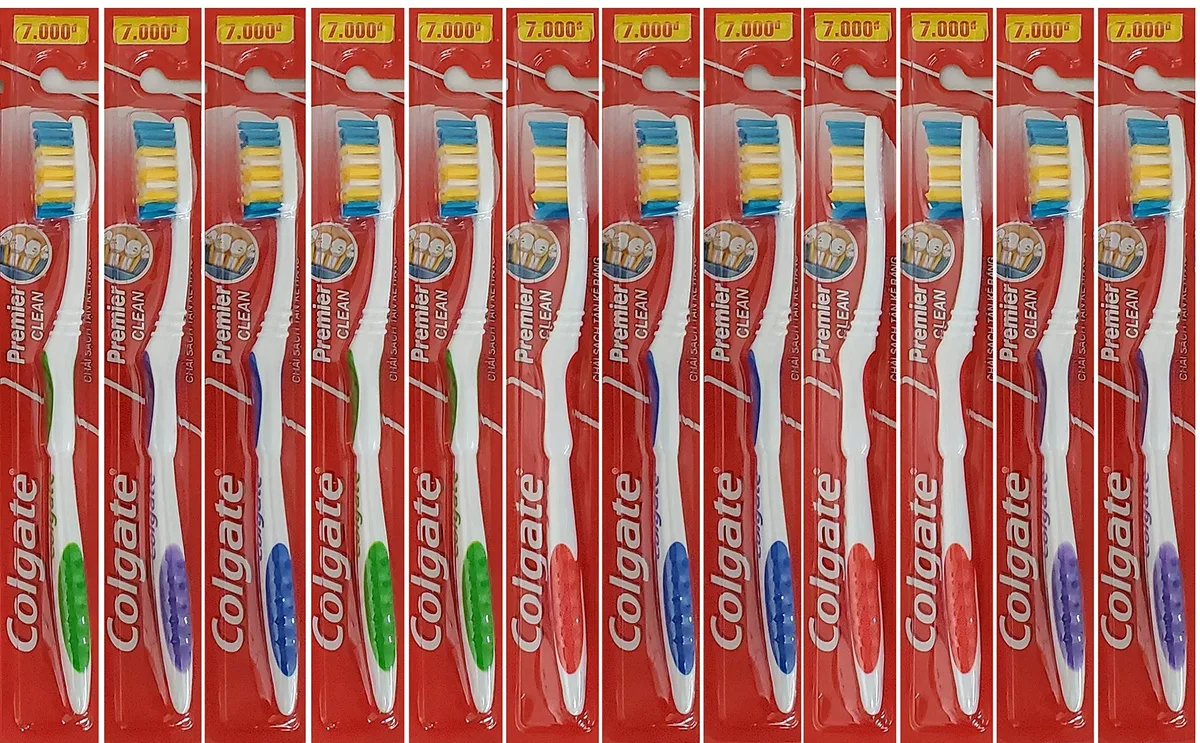 Pack of twelve multicoloured manual toothbrushes with medium bristles and tongue scraper