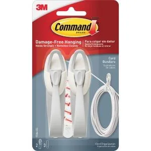 White plastic cord bundlers with hook-and-loop straps and adhesive strips on a card