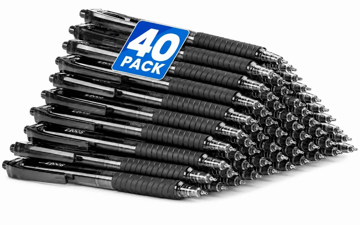 A clear plastic box holding forty black retractable ballpoint pens with soft rubber grips and pocket clips